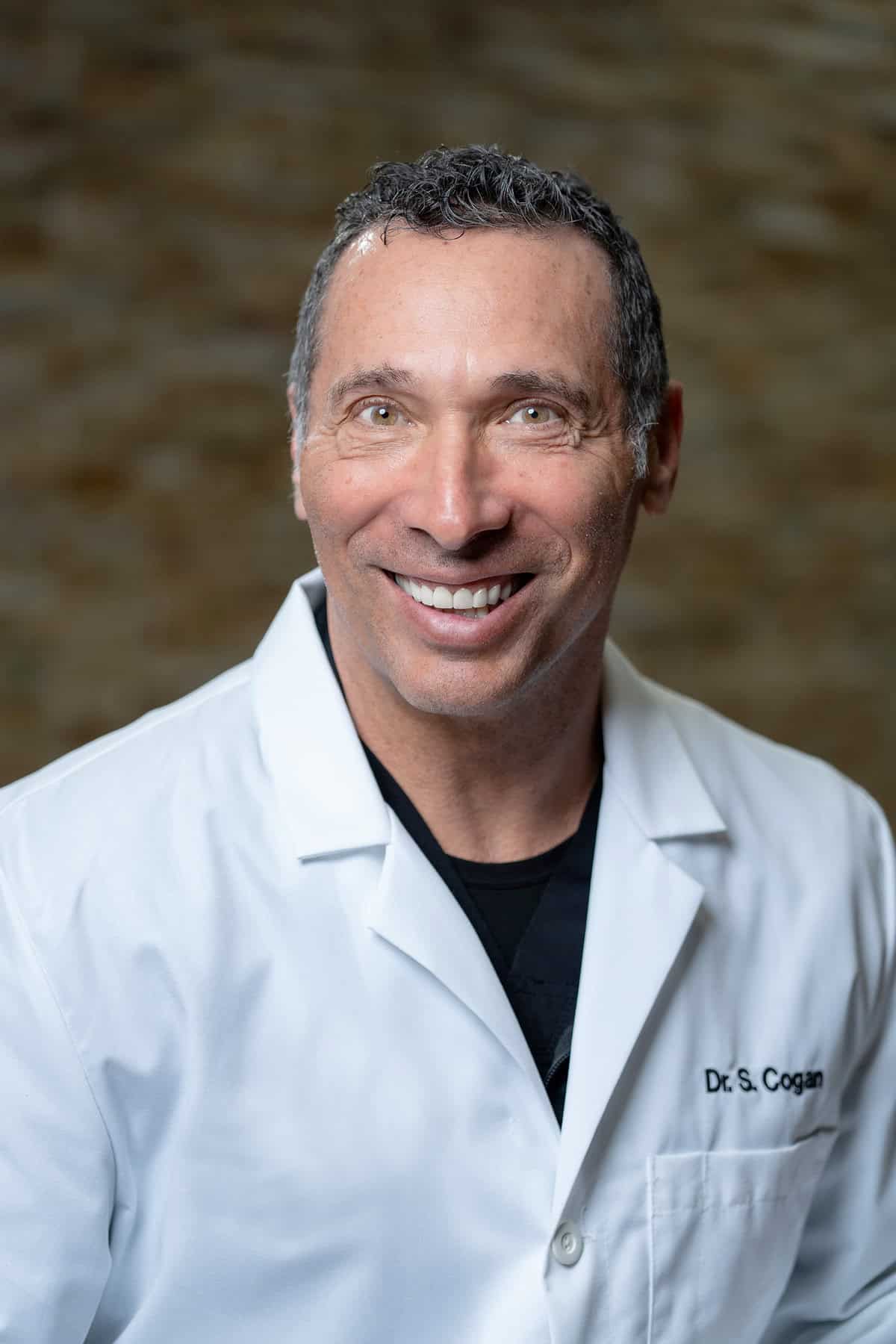 Experienced doctor at Nerve & Disc Institute smiling confidently.
