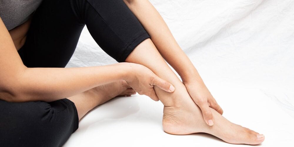 Person experiencing leg pain, seeking peripheral neuropathy treatment.