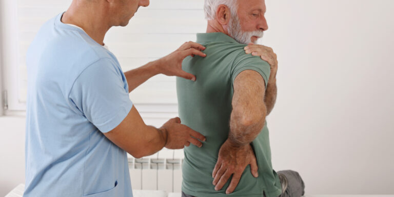 Senior,Man,With,Back,Pain.,Spine,Physical,Therapist,And,Paient.
