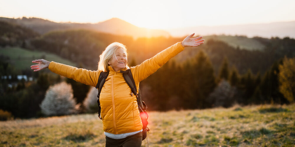 Woman enjoying outdoor scenery, representing nerve and disc health relief.